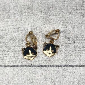 Vintage clip on black and white cat small charm earrings, makers mark.